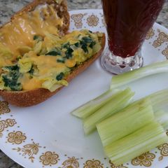 A picture of Spinach omelet in a bun.