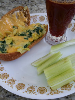 A picture of Spinach omelet in a bun.