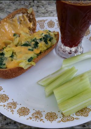 A picture of Spinach omelet in a bun.