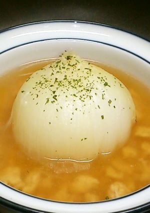A picture of Chinese Soup with Ground Chicken and a Whole Onion.