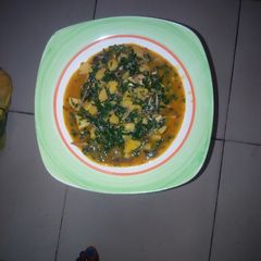 A picture of Plantain porridge with ugu leaves.