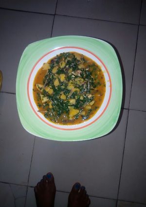 A picture of Plantain porridge with ugu leaves.