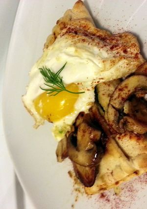 A picture of Greek Spanakopita topped w garlic fried egg.