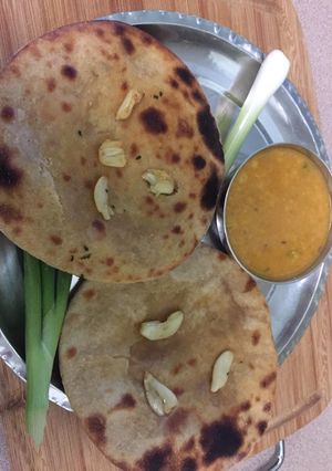 A picture of Dal tadka with oven garlic roti.