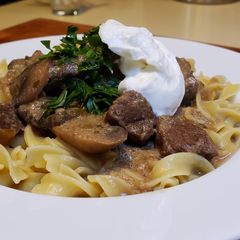 A picture of Beef Stroganoff Over Buttered Noodles.