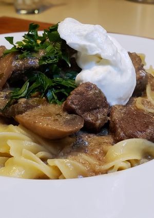 A picture of Beef Stroganoff Over Buttered Noodles.