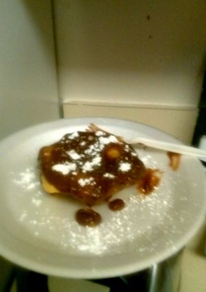 A picture of Cookie dough flautas with a peanut butter nutella sauce.