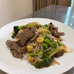 Beef in gravy sauce over rice A picture of Beef in gravy sauce over rice.