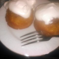 A picture of Mini pineapple upside-down cakes w/homemade whipped cream.