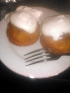 A picture of Mini pineapple upside-down cakes w/homemade whipped cream.
