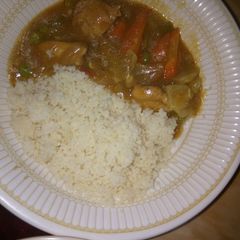 A picture of White rice and chicken veggie soup.