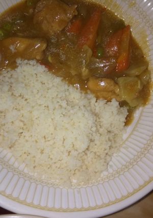 A picture of White rice and chicken veggie soup.