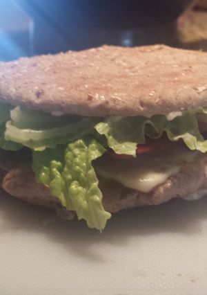 A picture of Turkey baconburger with grilled onion and garlic aioli.