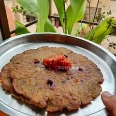A picture of Fenugreek and Coriander Leaves Flat Bread (Thalipeeth).
