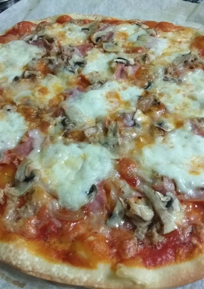 Una foto de Pizza de atún, jamón y champiñones