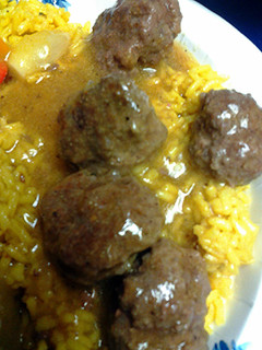 A picture of curry mini patties in sauce.