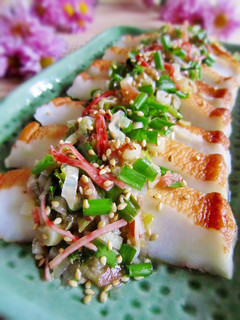 A picture of Sautéed Hanpen Fishcake with Sesame Seed and Japanese Leek Sauce.
