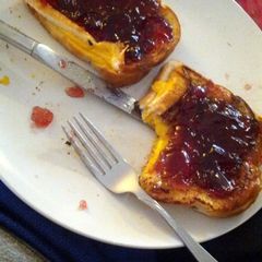 A picture of Grilled cheese sandwiches with jelly.