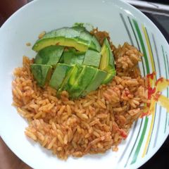 A picture of Jollof rice and Avacado.