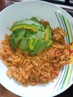 A picture of Jollof rice and Avacado.