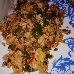 A picture of Scrambled eggs with veggies.