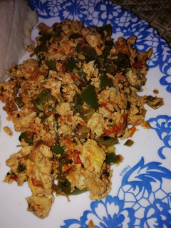 A picture of Scrambled eggs with veggies.