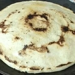 A picture of White sorghum chapati on clay tawa.