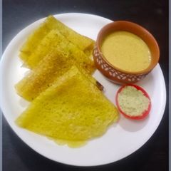 A picture of Tavsole (cucumber dosa) and Naral ras (coconut milk sweet).