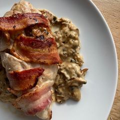 A picture of Mushroom stuffed chicken breast wrapped in bacon.