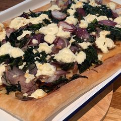 A picture of Caramelised onion, spinach and goats cheese tart.