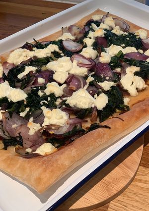 A picture of Caramelised onion, spinach and goats cheese tart.