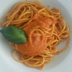 A picture of Dry pasta with tomato sauce.