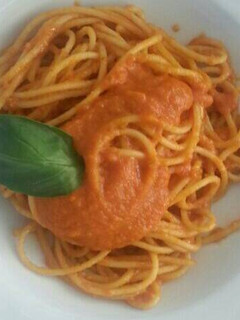 A picture of Dry pasta with tomato sauce.