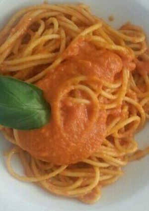 A picture of Dry pasta with tomato sauce.