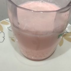 A picture of Sago milk with Rooh afza syrup.