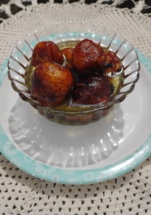 A picture of Dryfruit stuffed Gulab Jamun with Jaggery Syrup.