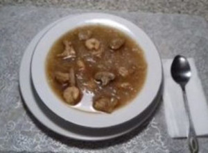 A picture of Chicken soup with Rice vermicelli, shrimp, and mushrooms.