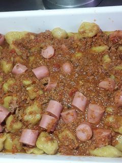 Una foto de Ñoquis de calabaza y harina con salsa boloñesa y salchichas