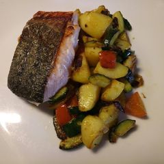 A picture of Pan fried salmon with sautéed veg.