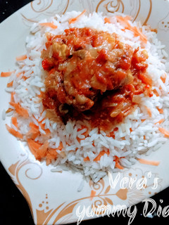 A picture of Rice and tomatoes sauce.
