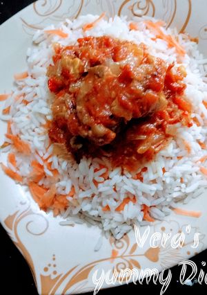 A picture of Rice and tomatoes sauce.