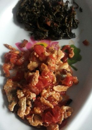 A picture of Fried eggs  served with greens.