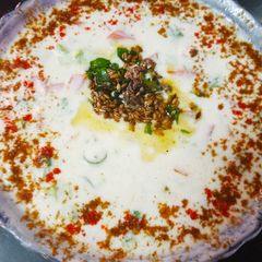 A picture of Tomato cucumber raita.