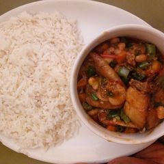 A picture of White rice and chicken sauce.