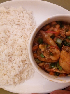 A picture of White rice and chicken sauce.