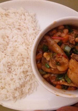 A picture of White rice and chicken sauce.