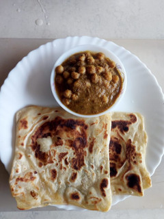 A picture of Maida chapati with chic peas gravy.