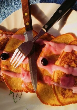 A picture of Soufflé pancakes topped with blueberry cream.