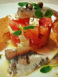 Una foto de Tartar de queso fresco y tomate con sardinas anchoadas