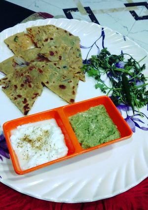 A picture of Pyaj ka paratha with curd or green chutney.